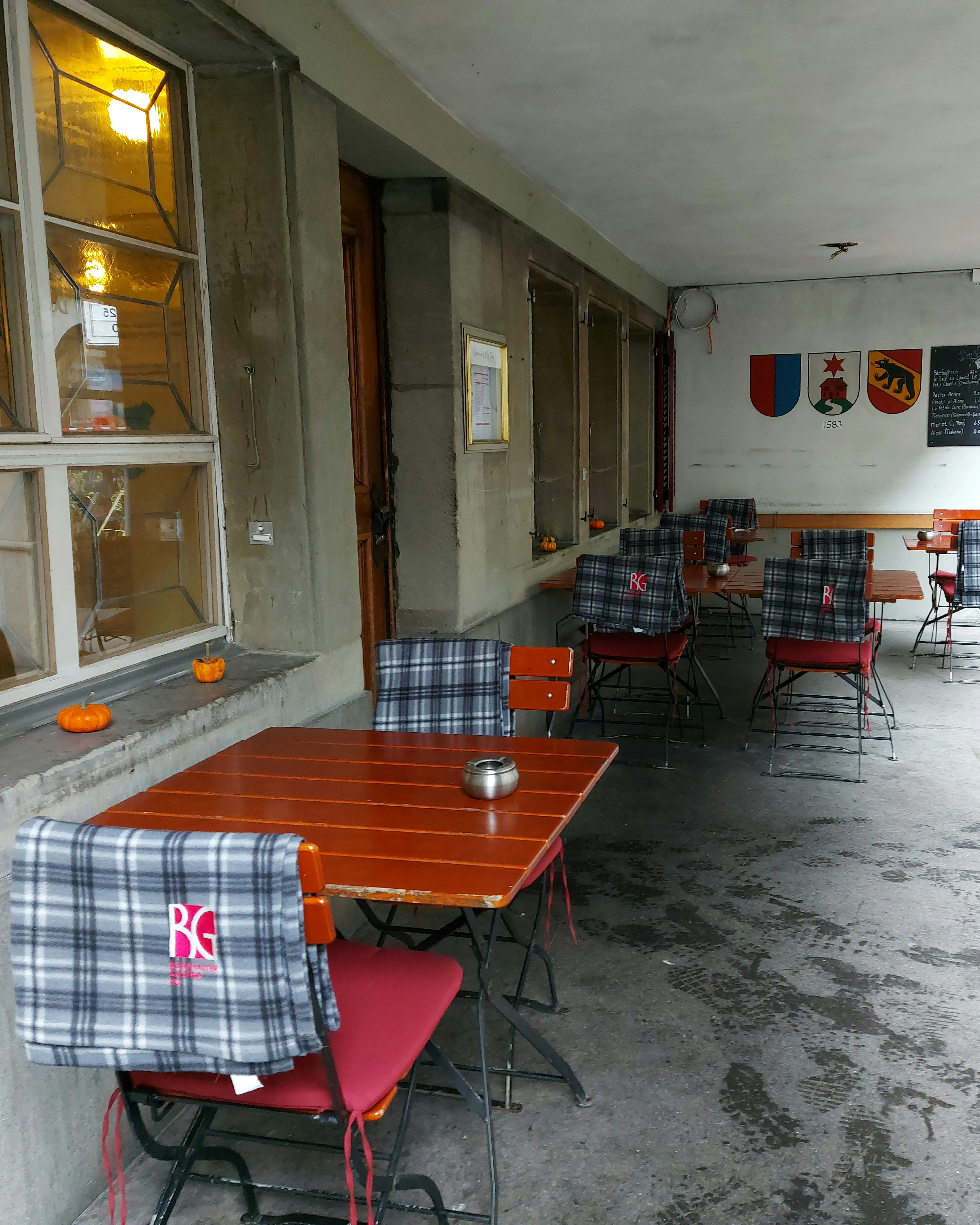 Outdoor seating in the historic sandstone arcade in front of Della Casa Bern.