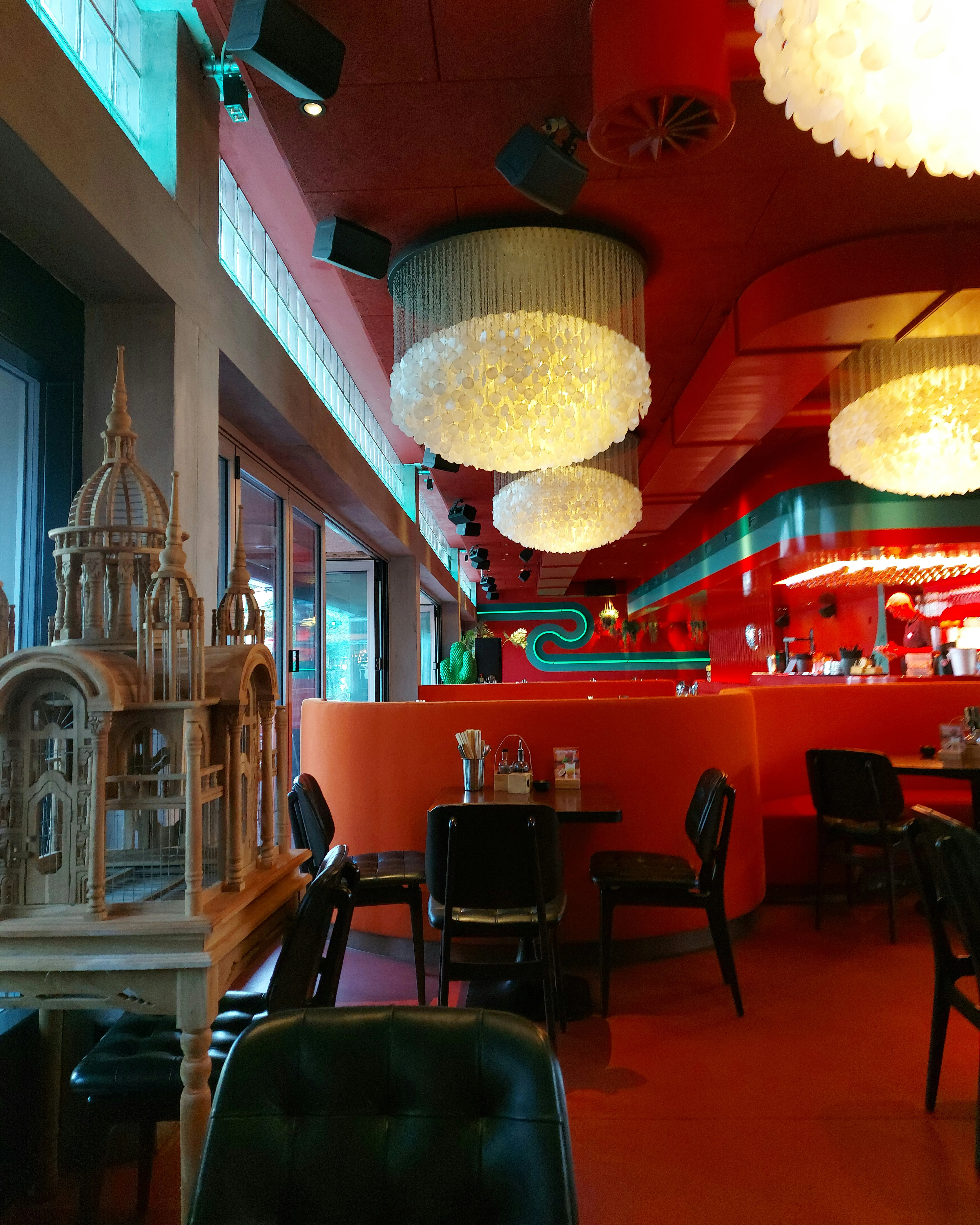 Interior of Nooch Asian Kitchen Bern Viktoriaplatz with dark wood tables and red accents
